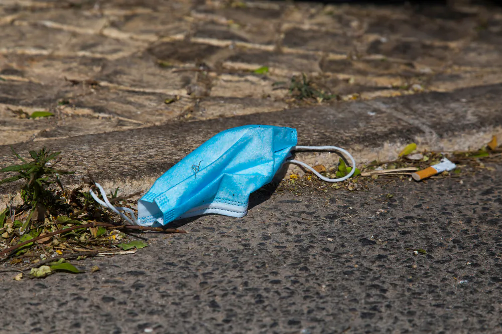 A mask lies on the ground in a file photograph. (John Fredricks/The Epoch Times)
