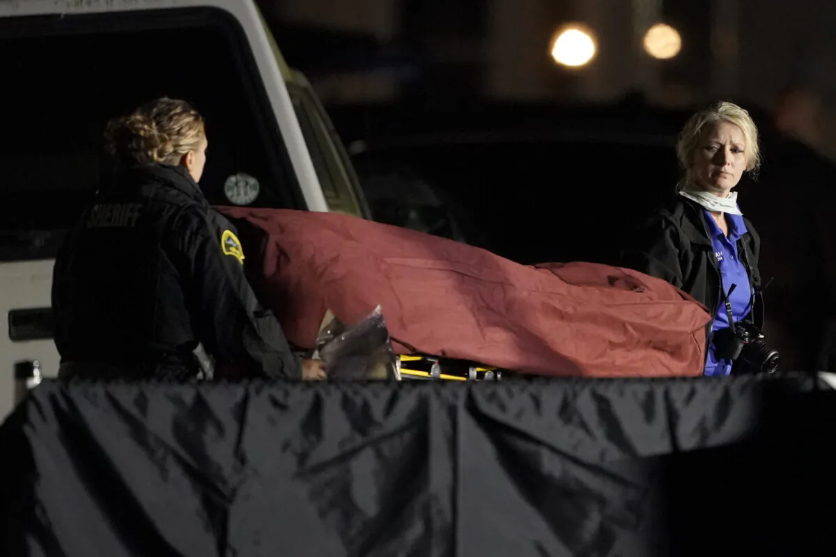The body of Michael Reinoehl is taken away on a stretcher in in Lacey, Wash., early Sept. 4, 2020. (Ted S. Warren/AP Photo)