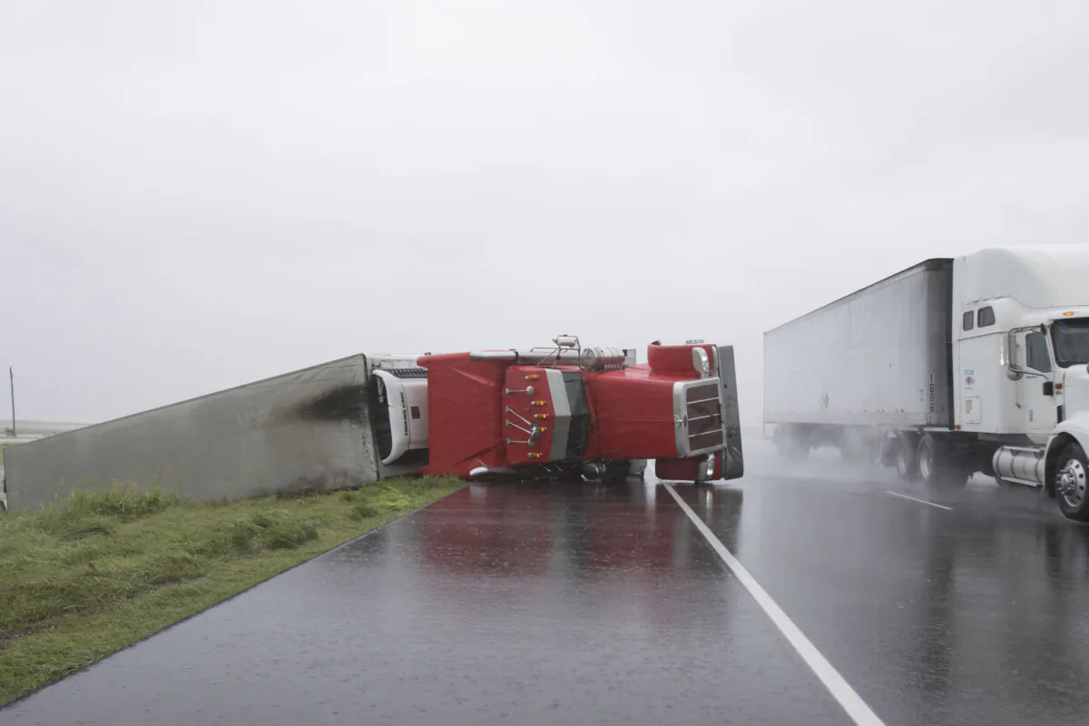 A big rig lies on it's side on Hwy 59 near Edna, Texas, south of Houston, in the aftermath of Hurricane Harvey on Aug. 26, 2017. (Daniel Kramer/AFP via Getty Images)