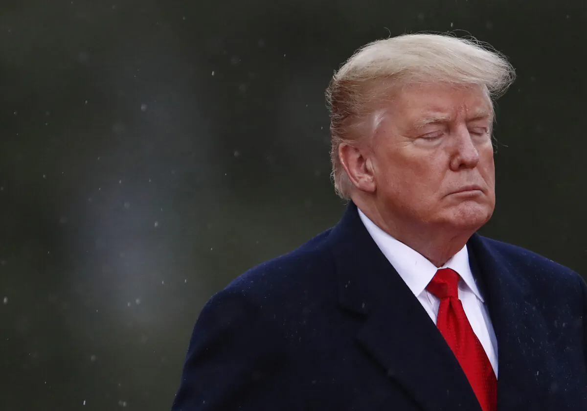 President Donald Trump closes his eyes as he visits the American Cemetery of Suresnes, outside Paris, as part of Veterans Day and the commemorations marking the 100th anniversary of the Nov. 11, 1918, armistice, ending World War I, on Nov. 11, 2018. (Christian Hartmann/AFP via Getty Images)