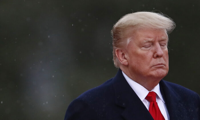 President Donald Trump closes his eyes as he visits the American Cemetery of Suresnes, outside Paris, as part of Veterans Day and the commemorations marking the 100th anniversary of the Nov. 11, 1918, armistice, ending World War I, on Nov. 11, 2018. (Christian Hartmann/AFP via Getty Images)