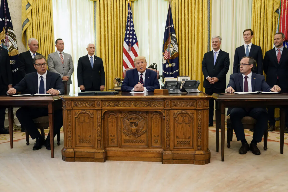 President Donald Trump participates in a signing ceremony with Serbian President Aleksandar Vucic, seated left, and Kosovar Prime Minister Avdullah Hoti, seated right, in the Oval Office of the White House, in Washington on Sept. 4, 2020. (Evan Vucci/AP Photo}
