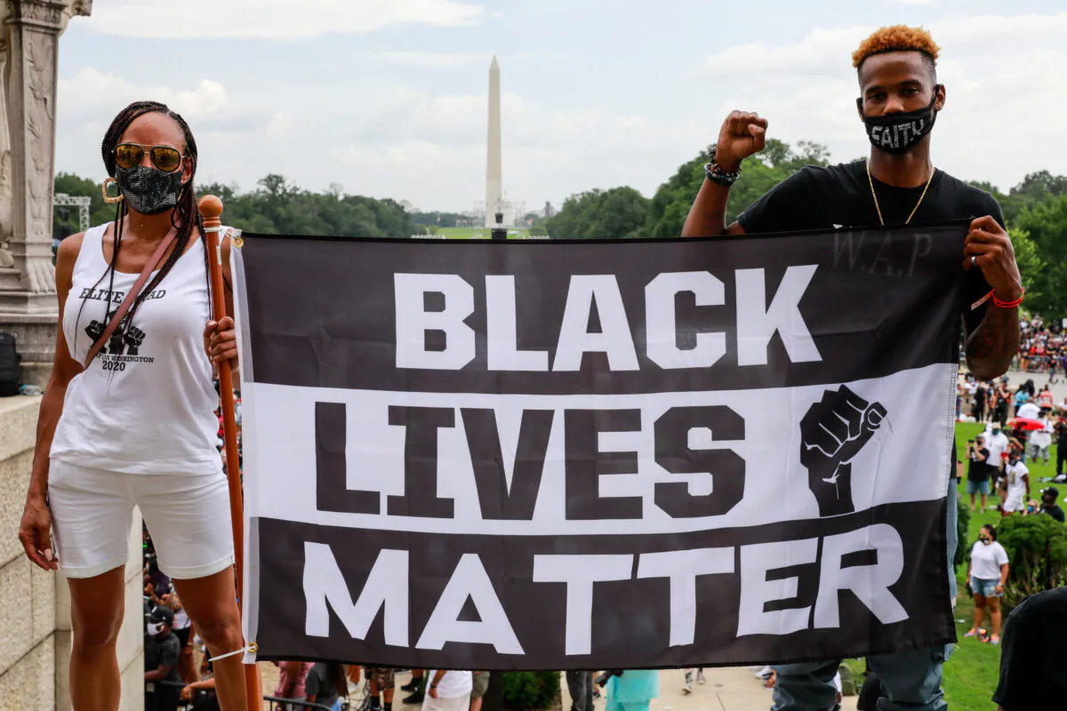 Protesters hold a sign in support of Black Lives Matter during the Commitment March in Washington on Aug. 28, 2020.  (Natasha Moustache/Getty Images)