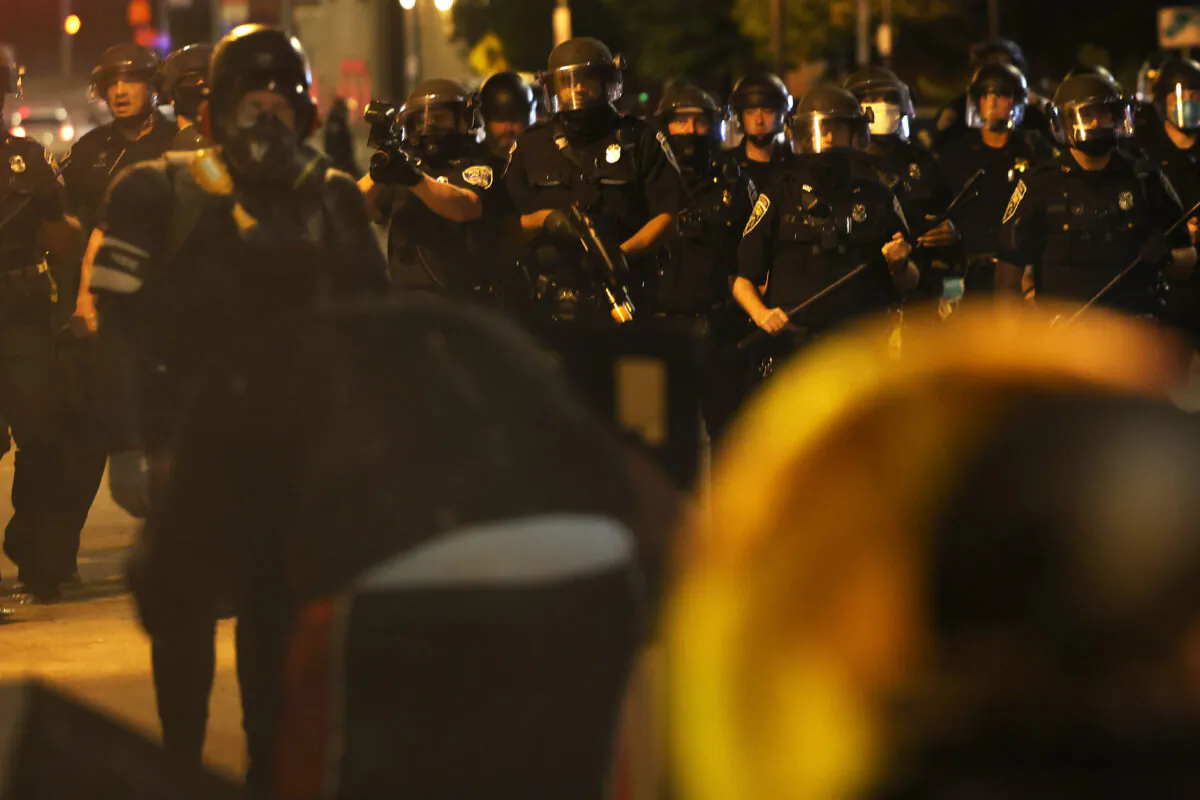 Police officers attempt to clear the streets after a march for Daniel Prude in Rochester, N.Y., Sept. 4, 2020. (Michael M. Santiago/Getty Images)