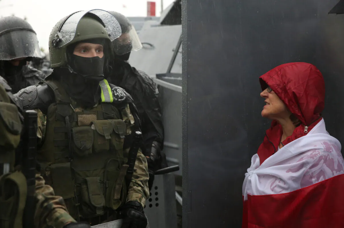 A participant addresses a Belarusian service member during an opposition rally to protest against police brutality and to reject the presidential election in Minsk, on Sept. 6, 2020. (Tut.By via Reuters)