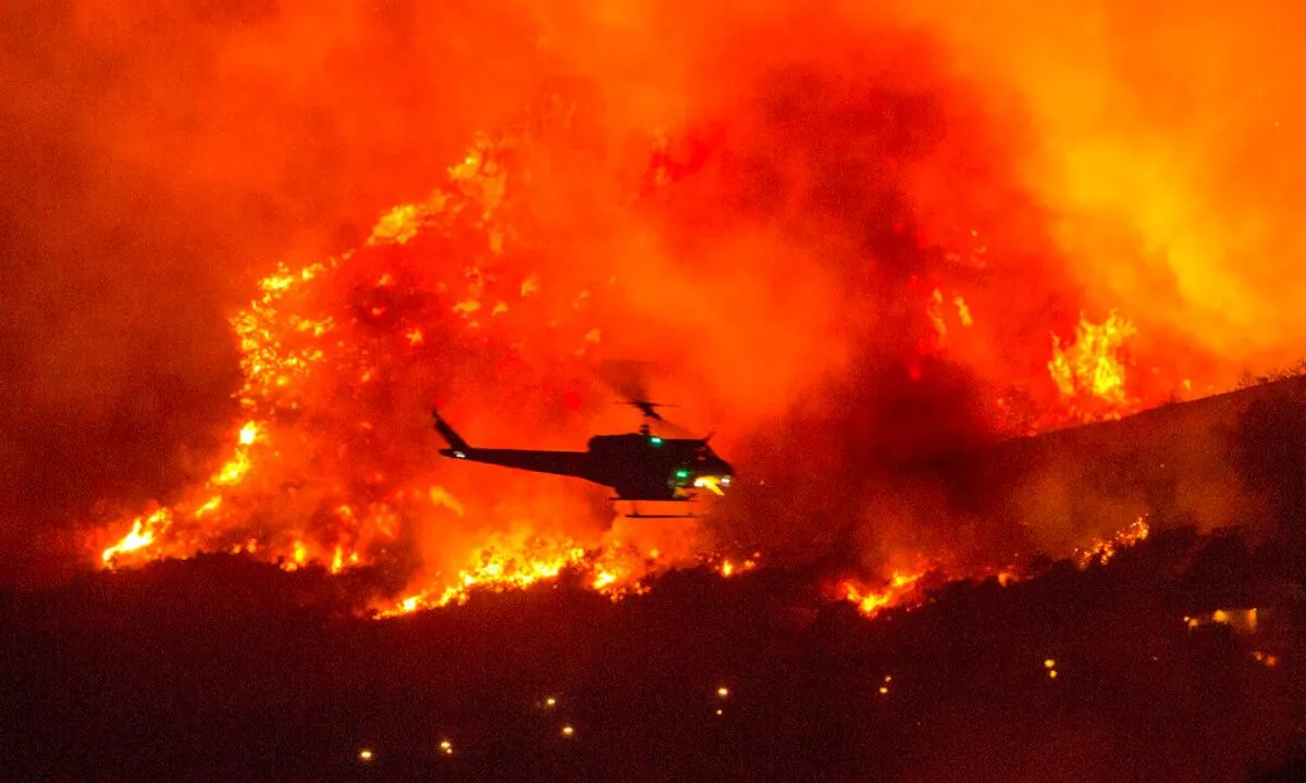 A helicopter prepares to drop water at a wildfire in Yucaipa, Calif., on Sept. 5, 2020. (Ringo H.W. Chiu/AP Photo) 