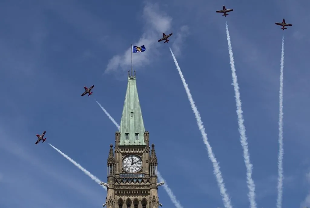 Royal Canadian Air Force Snowbirds fly past the Peace Tower during the Canada Day noon show on Parliament Hill in Ottawa on July 1, 2019.  (The Canadian Press/Justin Tang)