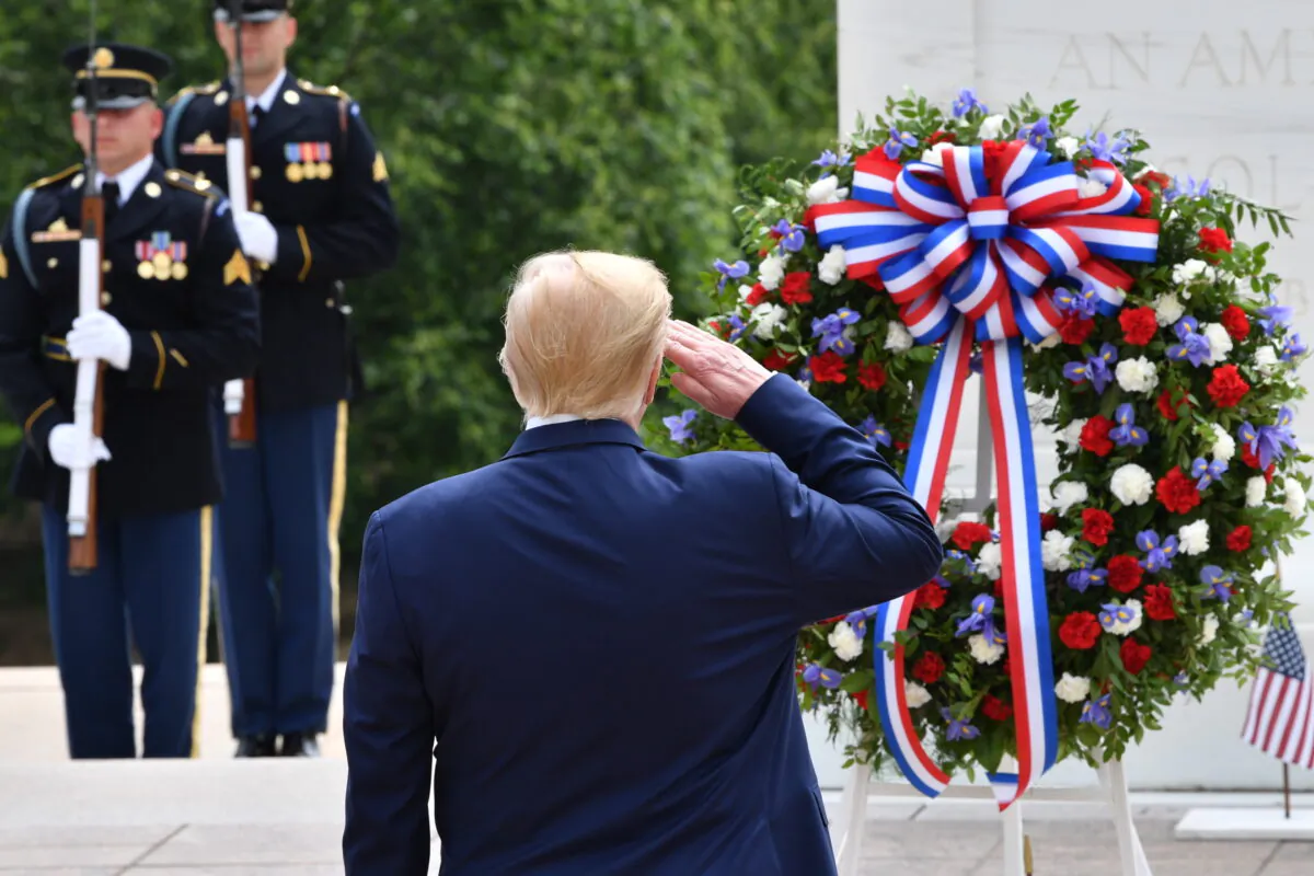 President Donald Trump salutes as he participates in a wreath laying ceremony at the Tomb of the Unknown Soldier at Arlington National Cemetery to commemorate Memorial Day and honor those who have died while serving in the U.S. Armed Forces in Arlington, Virginia on May 25, 2020. (Nicholas Kamm/AFP via Getty Images)