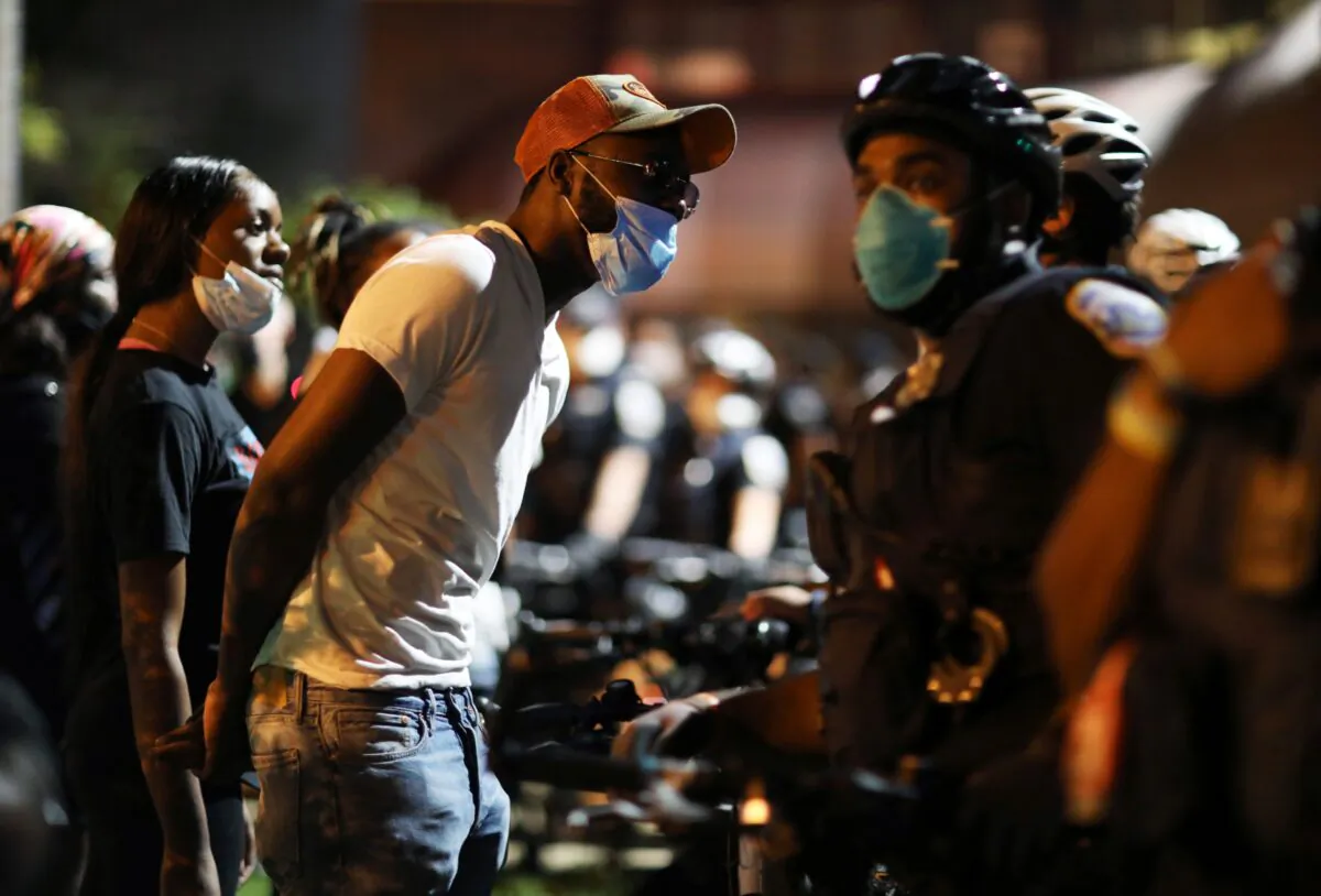 Protesters confront police officers outside of the 7th precinct in Washington on Sept. 2, 2020. (Leah Millis/Reuters)
