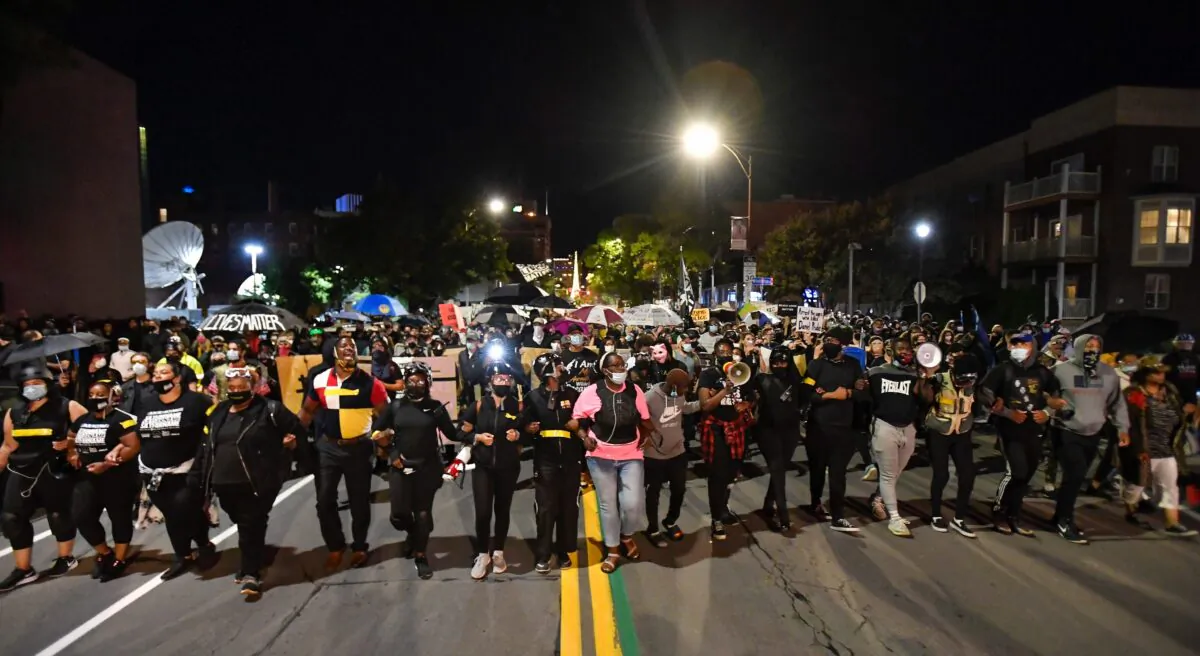 Demonstrators march through the streets protesting the death of Daniel Prude in Rochester, N.Y., on Sept. 4, 2020. (Adrian Kraus/AP Photo)