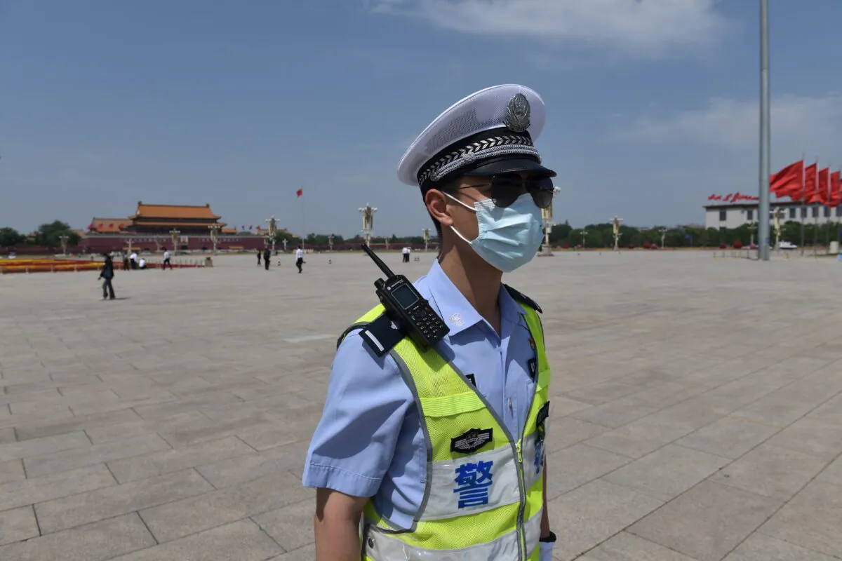 A policeman patrols in Tiananmen Square ahead of the closing session of the National People's Congress at the adjacent Great Hall of the People in Beijing on May 28, 2020. (Nicolas Asfouri/AFP via Getty Images)