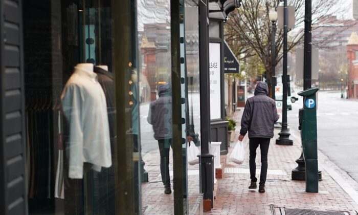 A lone man walks on M Street in the normally busy shopping district of Georgetown in Washington, D.C., on March 23, 2020. (Mandel Ngan/AFP via Getty Images)