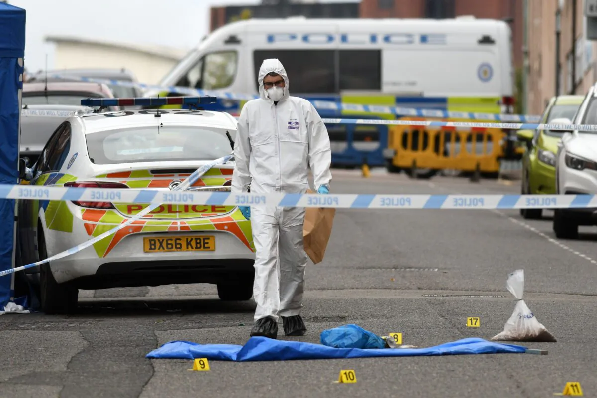 A police forensics officer gathers evidence near to evidence markers inside a cordon on Irving Street, following a major stabbing incident in the centre of Birmingham in central England on Sept. 6, 2020. (Oli Scarff/AFP via Getty Images)