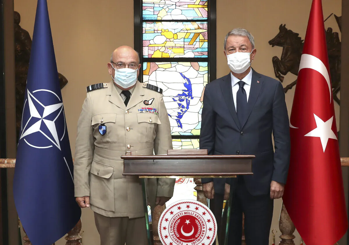 Turkey's Defense Minister Hulusi Akar, right, and Gen. Stuart Peach, the chairman of the NATO Military Committee, pose for photos before talks in Ankara, Turkey, on Sept. 7, 2020. (Turkish Defense Ministry / AP Photo)