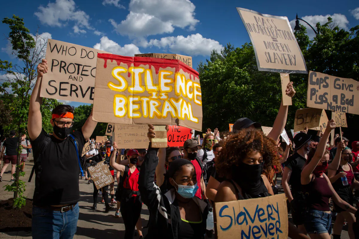 Protesters hold up placards as they march during a demonstration in Pittsburgh, Pa., on June 6, 2020. (Maranie R. Staab/AFP via Getty Images)