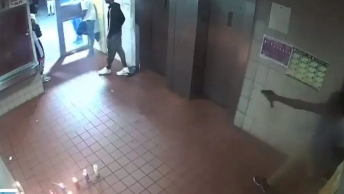 A man can be seen brandishing a weapon before a shootout . (NYPD Crimestoppers)


