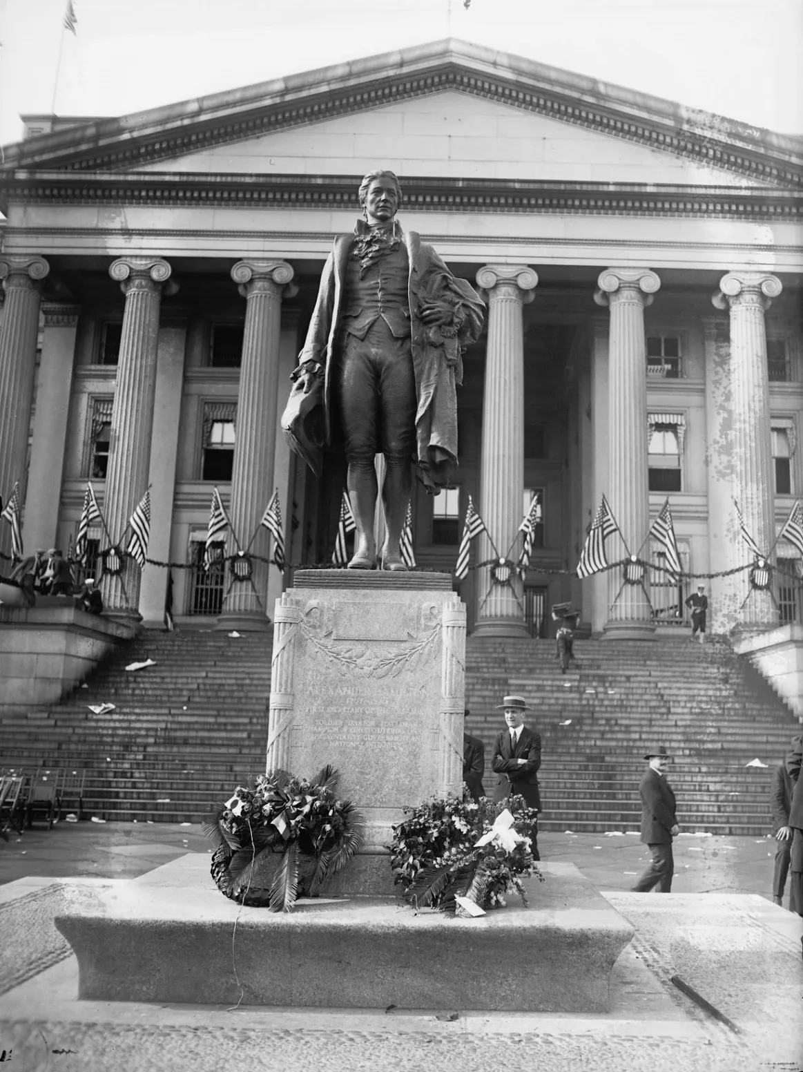 The 1923 dedication ceremony for James Earle Fraser's bronze statue of Alexander Hamilton on the south side of the Treasury Building in Washington. Library of Congress. (Public Domain)