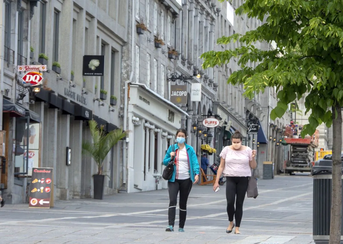 People walk past closed restaurants and bars in Old Montreal on June 4, 2020. (The Canadian Press/Ryan Remiorz)