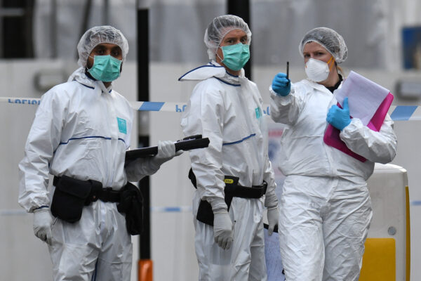 Police forensics officers gather evidence inside a cordon on Hurst Street, following a major stabbing incident in the centre of Birmingham in central England