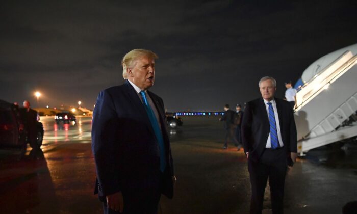 President Donald Trump, next to White House chief of staff Mark Meadows, speaks to reporters upon arrival at Andrews Air Force Base in Maryland on Sept. 3, 2020. (Mandel Ngan/AFP via Getty Images)