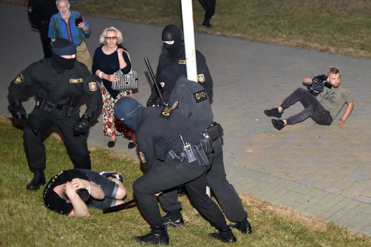 Riot police detain a demonstrator during a protest after polls closed in Belarus' presidential election, in Minsk on Aug. 9, 2020. (Sergei Gapon/AFP via Getty Images)