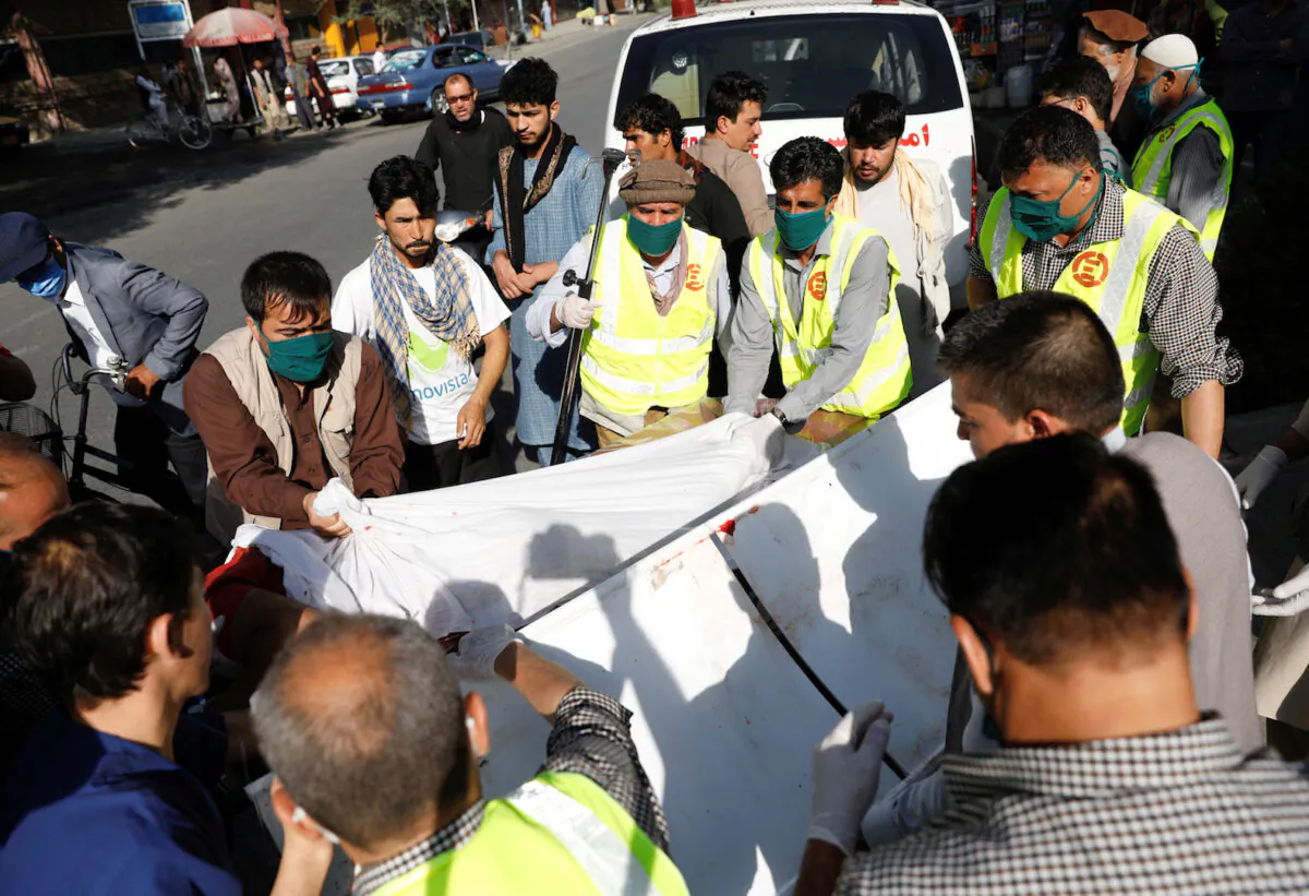 Afghan men carry an injured to a hospital after a blast in Kabul, Afghanistan on Sept. 9, 2020. (Mohammad Ismail/Reuters)