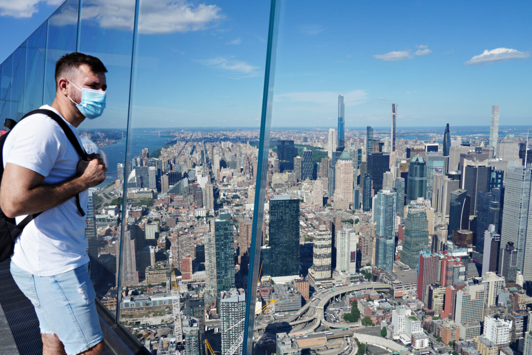 A person in a protective mask looks at the view as New York City continues Phase 4 of reopening following CCP virus restrictions, in New York City on Sept. 4, 2020. (Cindy Ord/Getty Images)