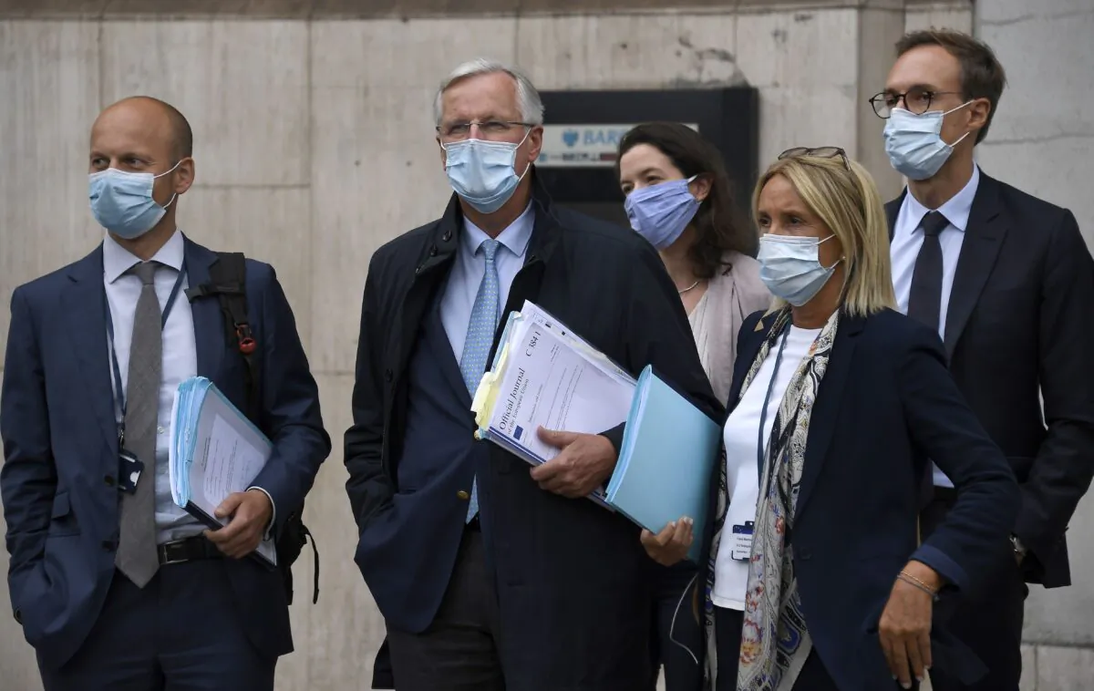 EU Chief negotiator Michel Barnier (Second L) arrives with his team at the Westminster Conference Centre in London on Sept. 9, 2020, where U.K. and EU officials began the eighth round of Brexit negotiations. (AP Photo/Alberto Pezzali)