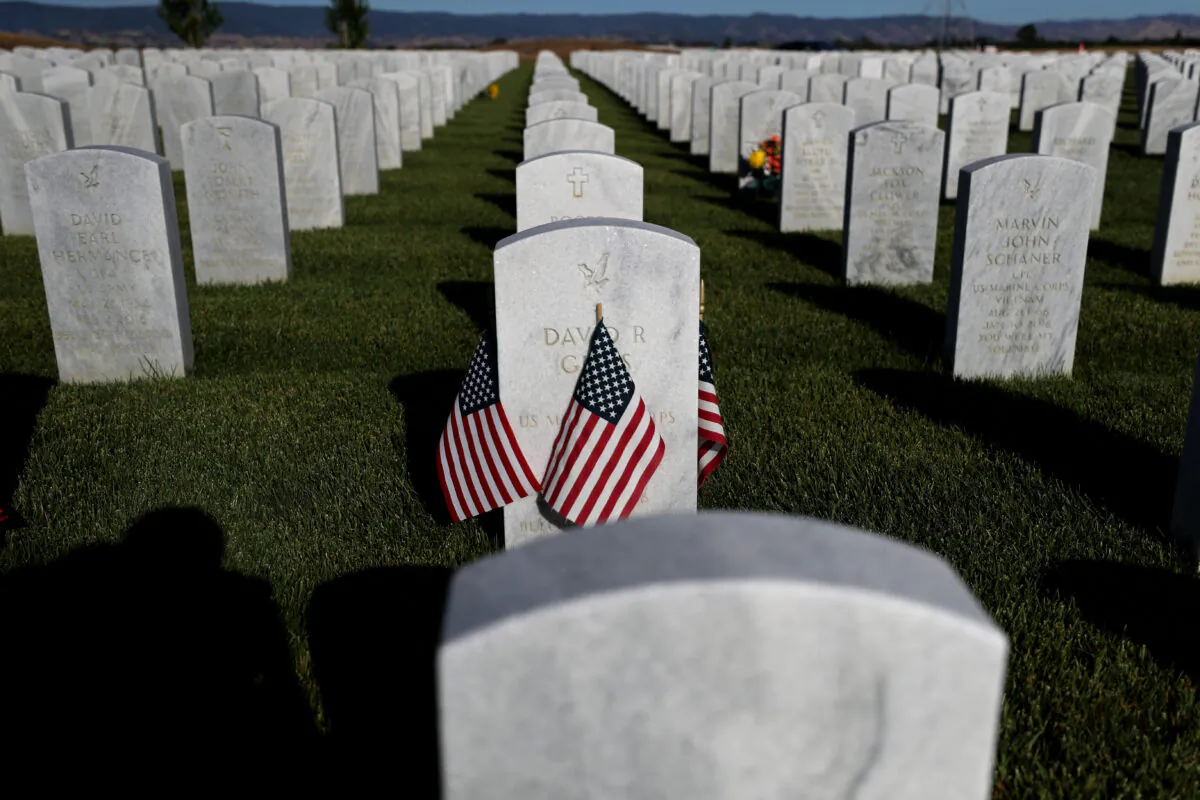 Flags are displayed next to headstones in Dixon, Calif., on May 24, 2020. (Justin Sullivan/Getty Images)
