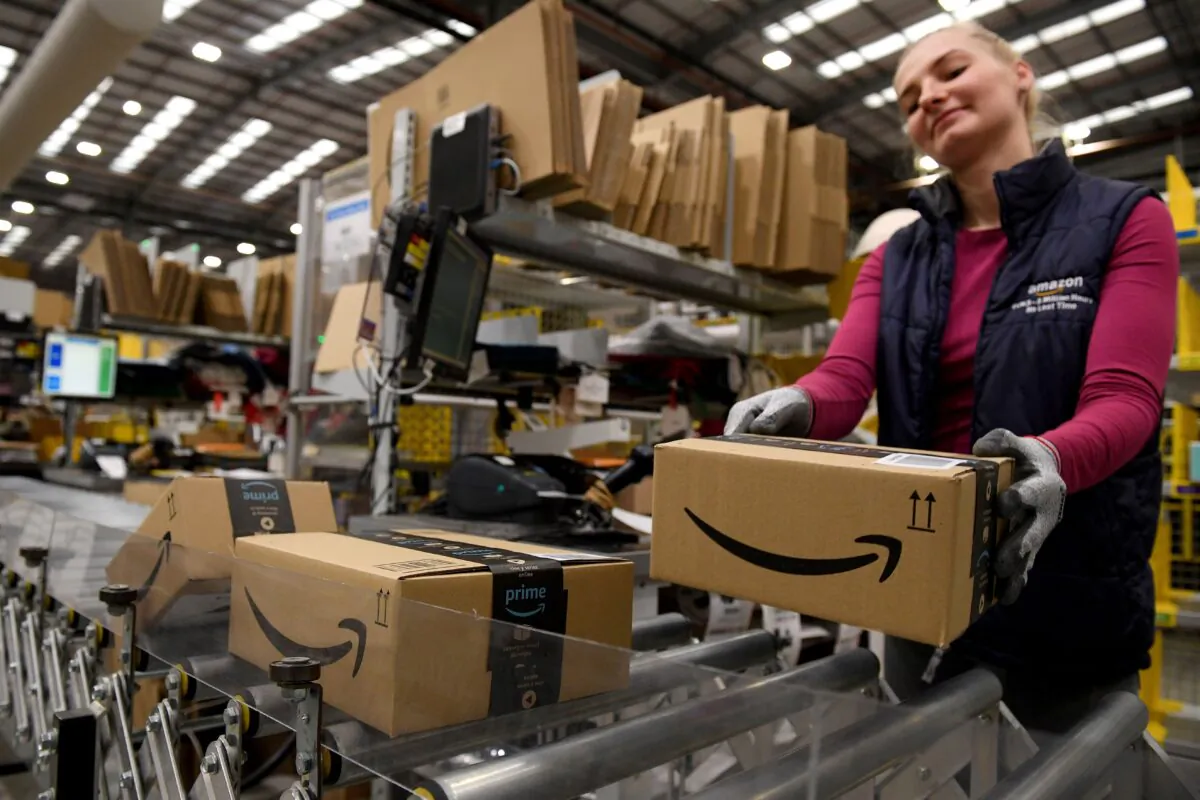 An Amazon worker packs items for the annual Black Friday Sale at the Amazon Fulfilment Centre in Peterborough, east England on Nov. 27, 2019. (Daniel Leal-Olivas/AFP via Getty Images)