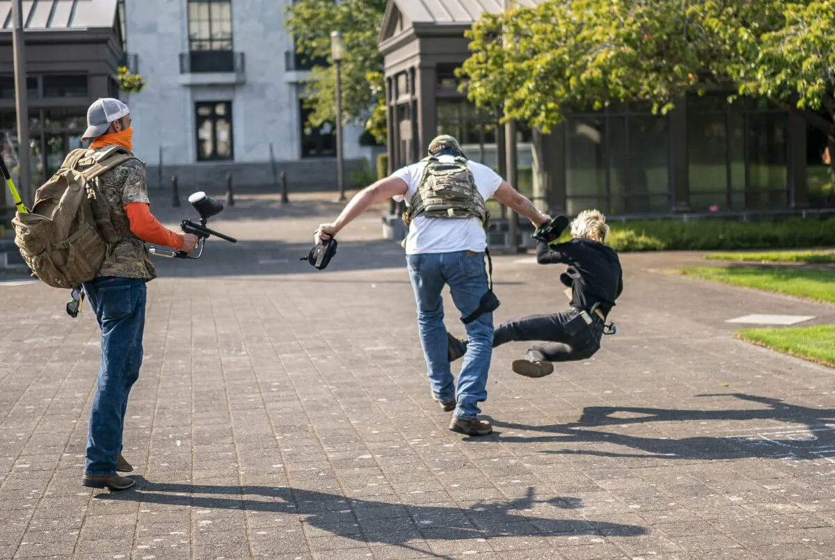 A man attacks a counter-protester during pro-President Donald Trump rally in Salem, Ore., on Sept. 7, 2020. (Nathan Howard/Getty Images)