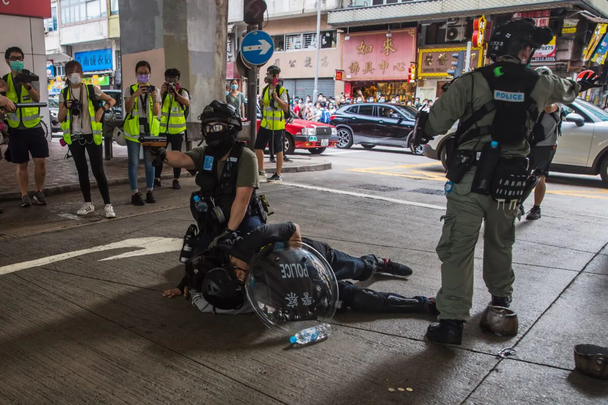 Riot police detain a man as they clear protesters taking part in a rally against a new national security law in Hong Kong on July 1, 2020, on the 23rd anniversary of the city's handover from Britain to China. (Dale de la Rey/AFP via Getty Images)