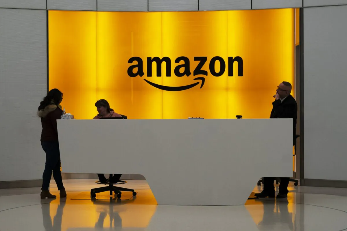 People stand in the lobby of Amazon offices in New York on Feb. 14, 2019. (Mark Lennihan/AP Photo)