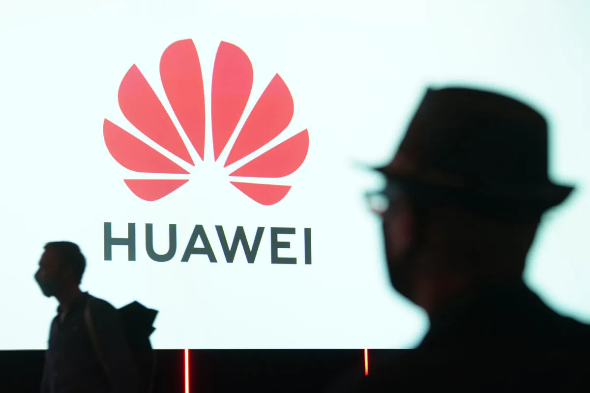 People arrive to attend the Huawei keynote address at the IFA 2020 Special Edition consumer electronics and appliances trade fair on the fair's opening day in Berlin, Germany, on Sept. 3, 2020. (Sean Gallup/Getty Images)