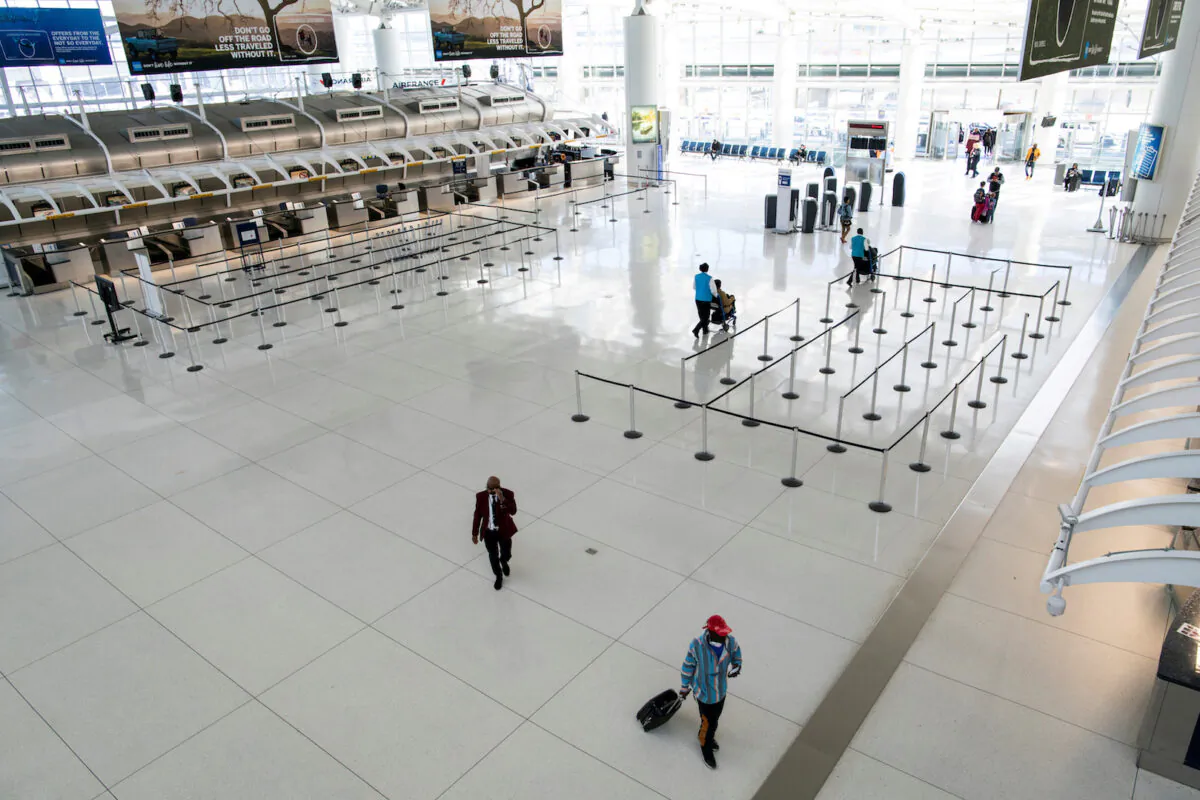 People walk around the terminal at the John F. Kennedy International Airport in New York on March 9, 2020. (Eduardo Munoz/File Photo via Reuters)