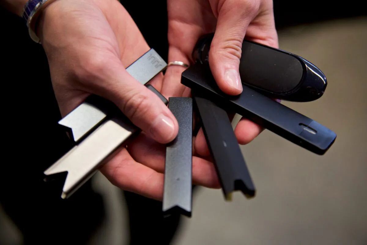 A researcher holds vape pens in a laboratory in Portland, Ore., on April 16, 2019. (Craig Mitchelldyer/AP Photo)