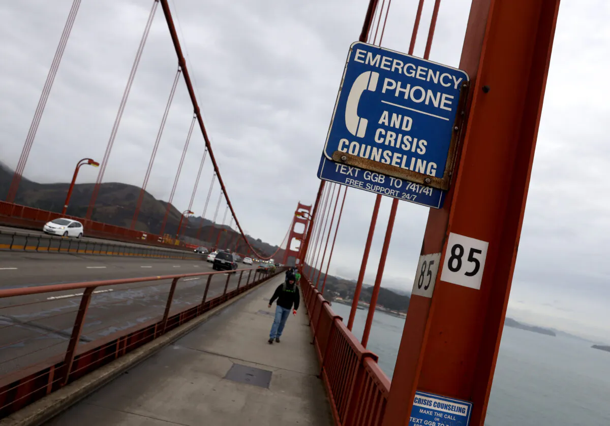 A sign is posted alerting people to use an emergency crisis counseling phone if in distress on the Golden Gate Bridge in San Francisco on Dec. 13, 2019. (Justin Sullivan/Getty Images)