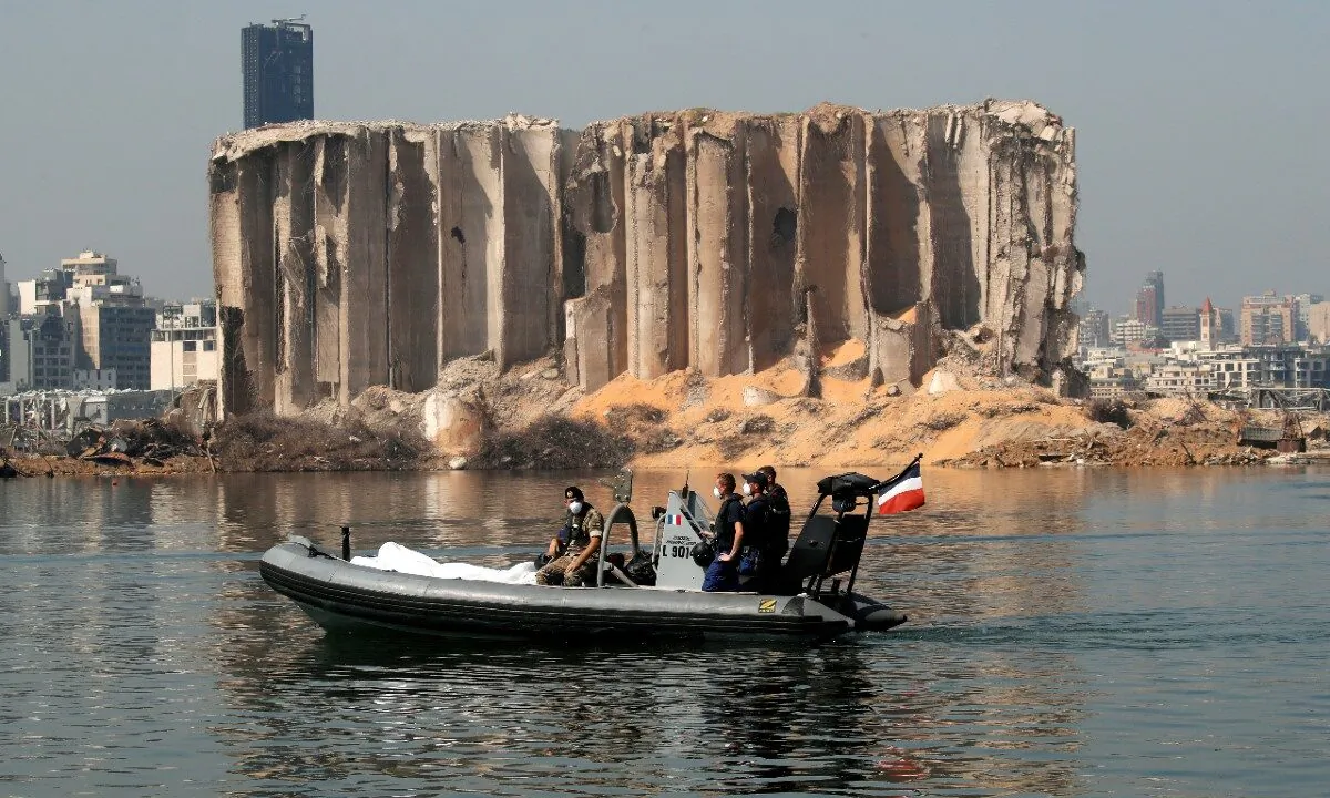 Members of the Lebanese army and the French military ride a boat past the damaged grain silo near site of the massive blast in Beirut's port area, in Beirut, Lebanon, on Aug. 31, 2020. (Gonzalo Fuentes/Reuters/Pool)