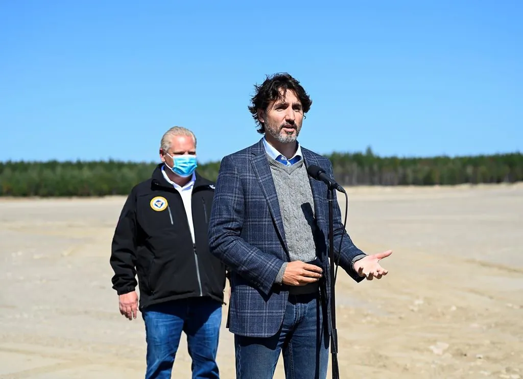 Canadian Prime Minister Justin Trudeau speaks as Ontario Premier Doug Ford listens after taking part in a ground-breaking event at the Iamgold Cote Gold mining site in Gogama, Ont., on Sept. 11, 2020. (The Canadian Press/Nathan Denette)