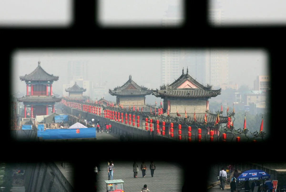 Tourists visit the Xian Ming Dynasty City Wall in Xian of Shaanxi Province, China, on Oct. 16, 2007. (China Photos/Getty Images)