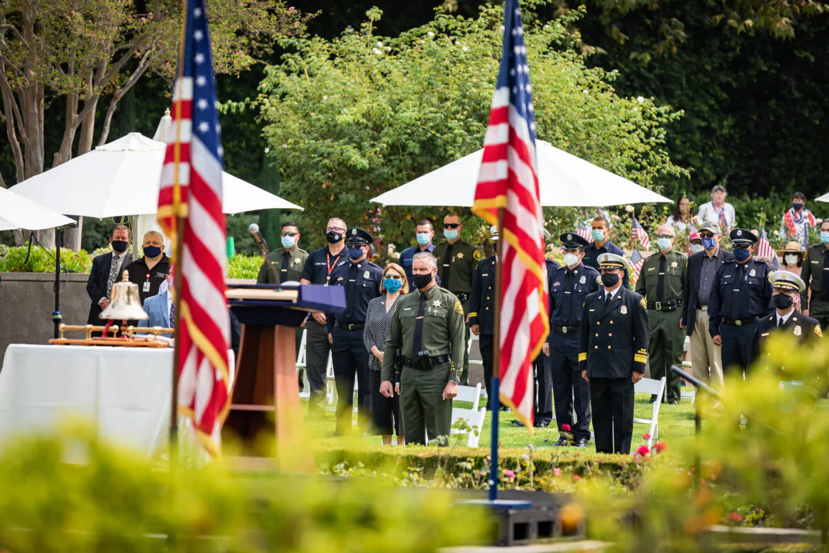 Orange County Sheriff Don Barnes, center, stands in front of uniformed first responders at the opening of the annual 9/11 memorial ceremony at the Richard Nixon Library and Museum in Yorba Linda, Calif., on Sept. 11, 2020. (John Fredricks/The Epoch Times)