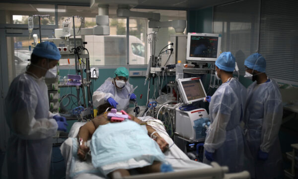 A medical crew works around a patient affected with COVID-19 in a Marseille hospital