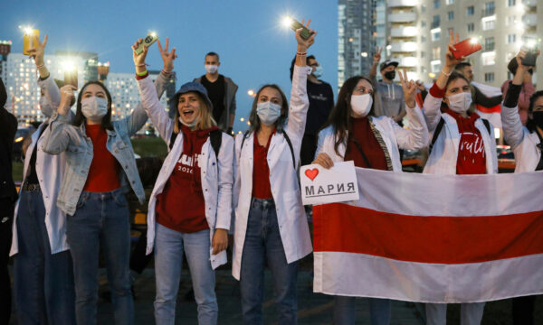Belarusian medical workers gesture during a rally