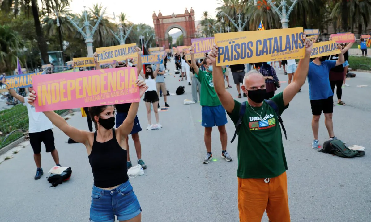 Pro-independence protesters hold placards as they attend a rally during Catalonia's day of 'La Diada' in Barcelona, Spain, on Sept. 11, 2020. (Nacho Doce/Reuters)
