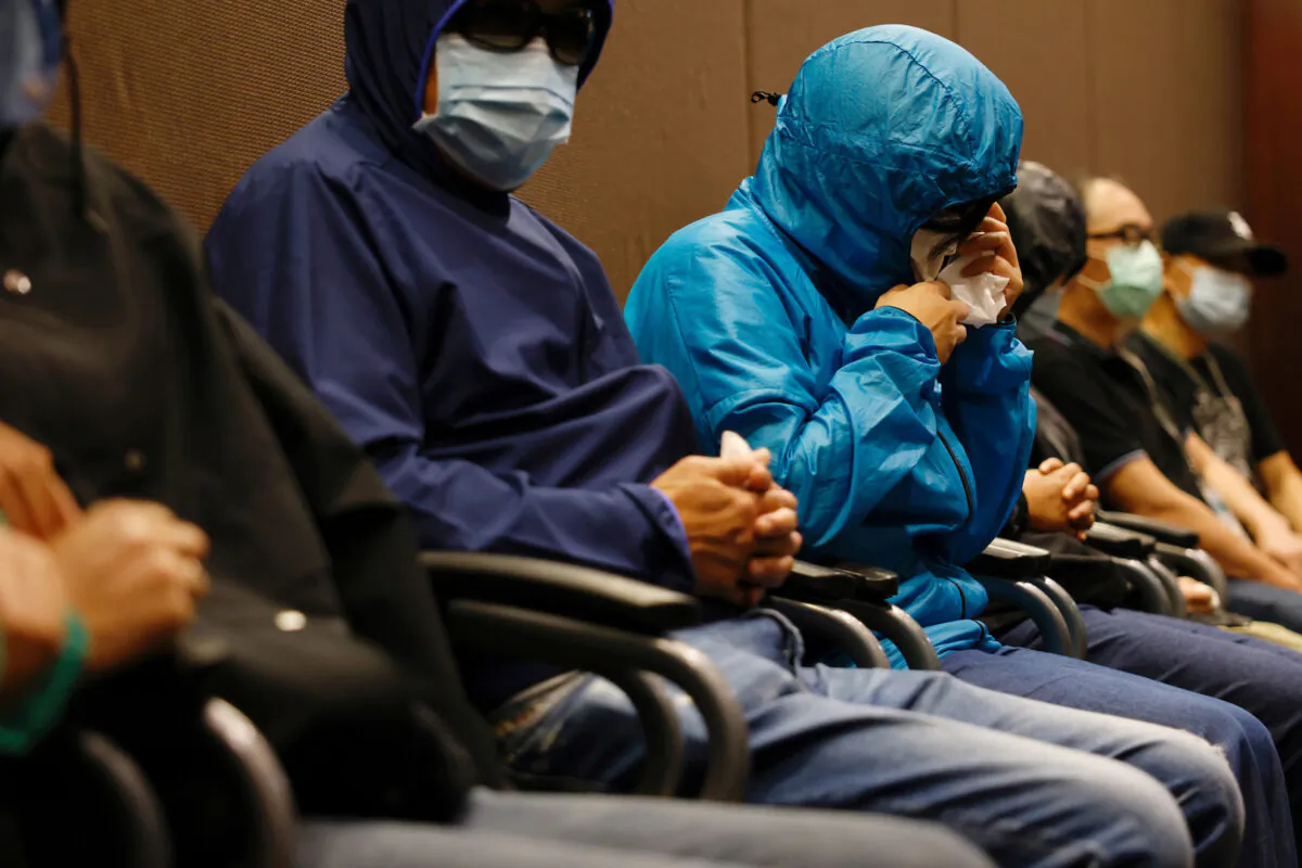 A family member of one of twelve Hong Kong activists who were detained as they reportedly sailed to Taiwan for political asylum, wipes her eyes during a news conference, held to seek help in Hong Kong, China on Sept. 12, 2020. (Tyrone Siu/Reuters)