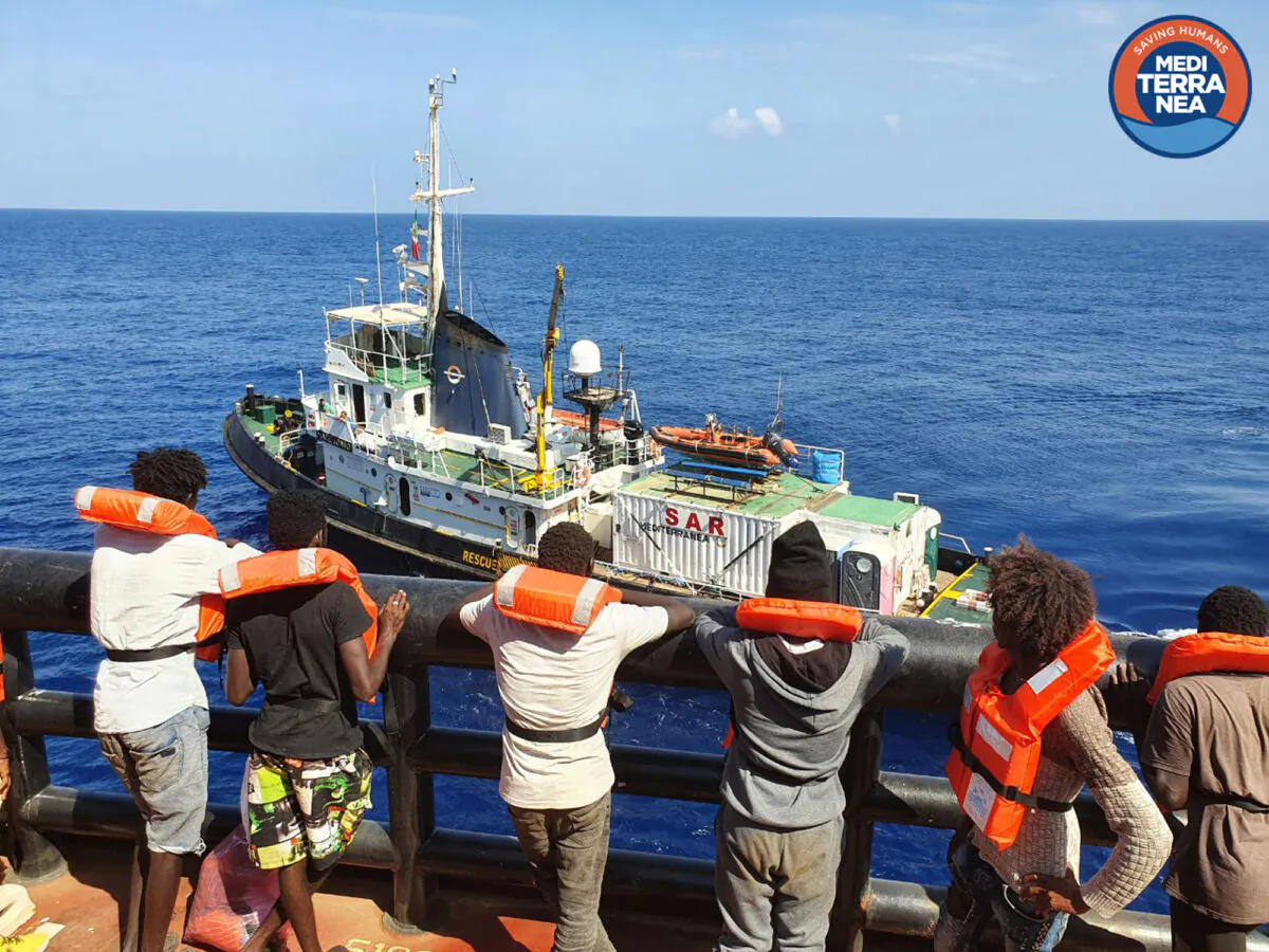 Migrants on the Danish-flagged tanker Maersk Etienne waiting to be transferred on the Mediterranea NGO's Mare Jonio rescue ship (background), in the Mediterranean Sea, on Sept. 11, 2020. (Mediterranea Saving Humans/AP)