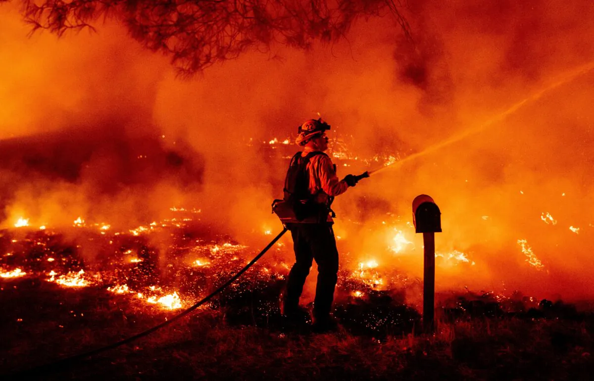 A Butte county firefighter douses flames at the Bear fire in Oroville, Calif., on Sept. 9, 2020. (Josh Edelson/AFP via Getty Images)