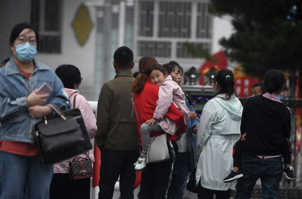 Parents wait outside a school in Tongliao, in northern China’s Inner Mongolia on September 10, 2020. (NOEL CELIS/AFP via Getty Images)