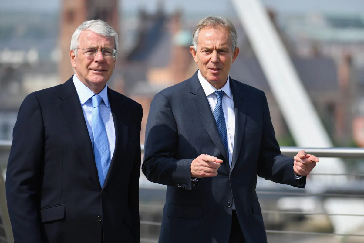 Sir John Major and Tony Blair speak as they walk across the Peace Bridge in Derry, Northern Ireland, on June 9, 2016. (Jeff J Mitchell-WPA Pool/Getty Images)