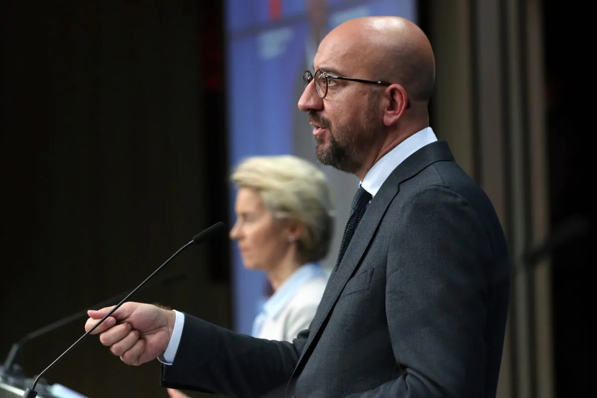 European Council President Charles Michel talks during an online press conference with European Commission President Ursula von der Leyen, background, and German Chancellor Angela Merkel following an EU-China virtual summit at the European Council building in Brussels, Belgium, on Sept. 14, 2020. (Yves Herman/Pool Photo via AP)